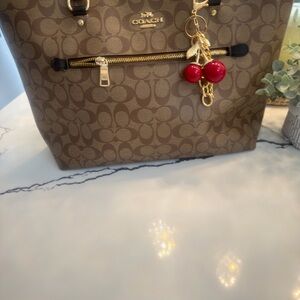 Coach Tan Monogram Handbag with Gold Accents